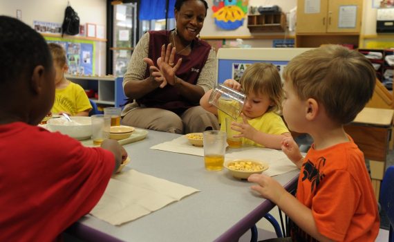 a teacher with small childrem